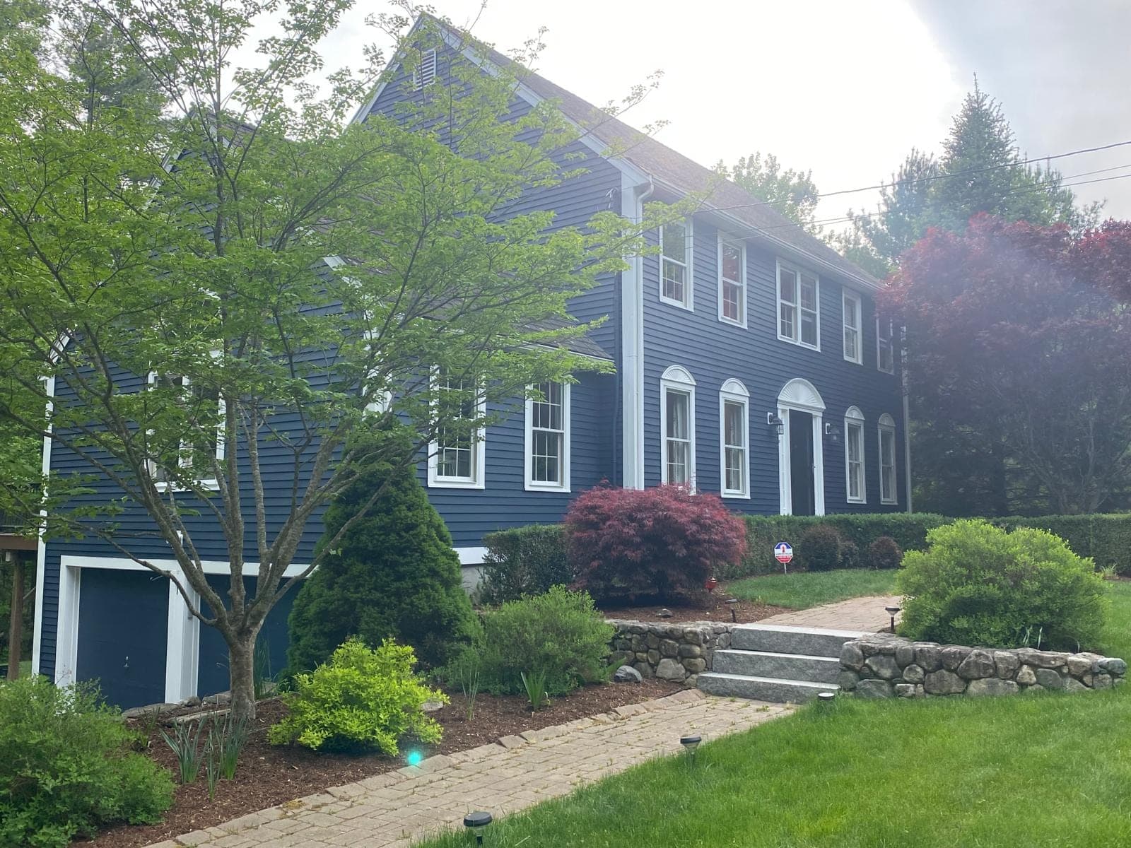 Weston, MA New England colonial home repainted in deep navy blue by AM Pro Painting